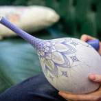 Rhian Malin decorating a mandala bottle in her workshop 2019